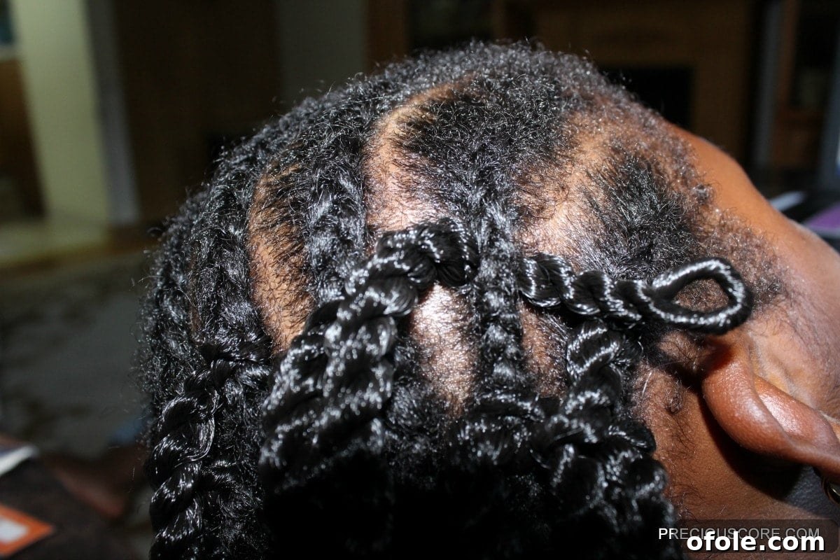 Step 4: Securing the crochet braid with a knot by feeding the tails through the loop and tightening