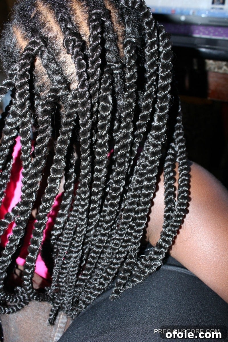 A child's head with a full set of neatly installed crochet braids, showcasing the completed style