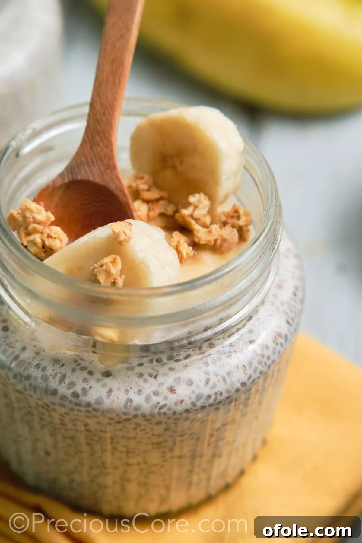Spoon resting in a jar of beautifully set banana chia pudding.