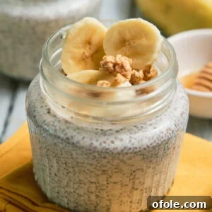 Close-up of a jar of banana chia pudding, with a spoon.