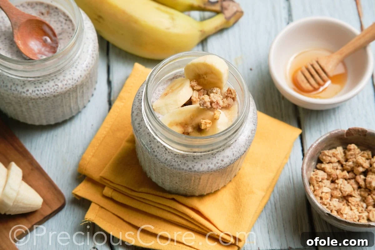 Close-up of banana chia seed pudding served in an elegant glass jar.