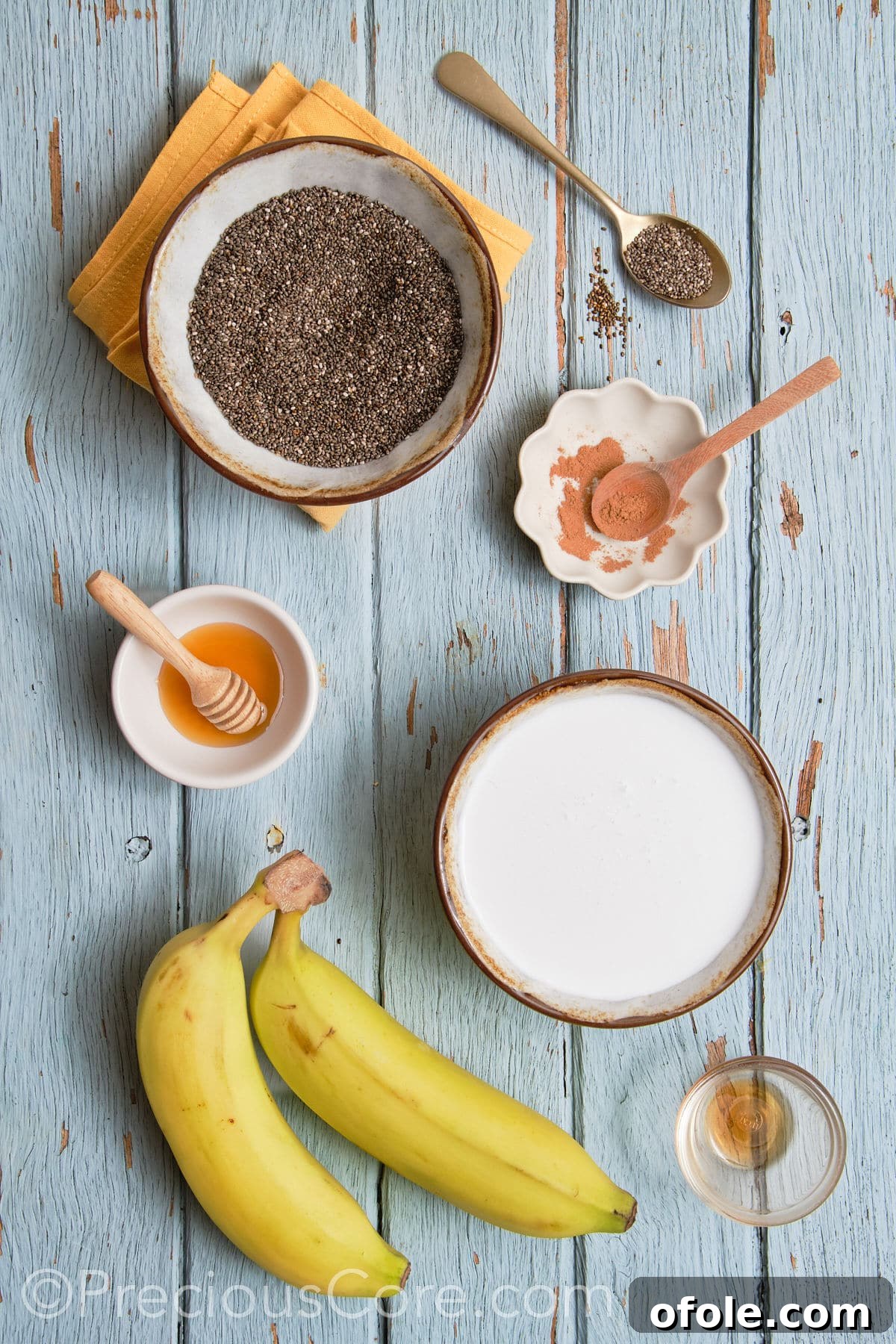 Various ingredients for Banana Chia Seed Pudding laid out on a surface.