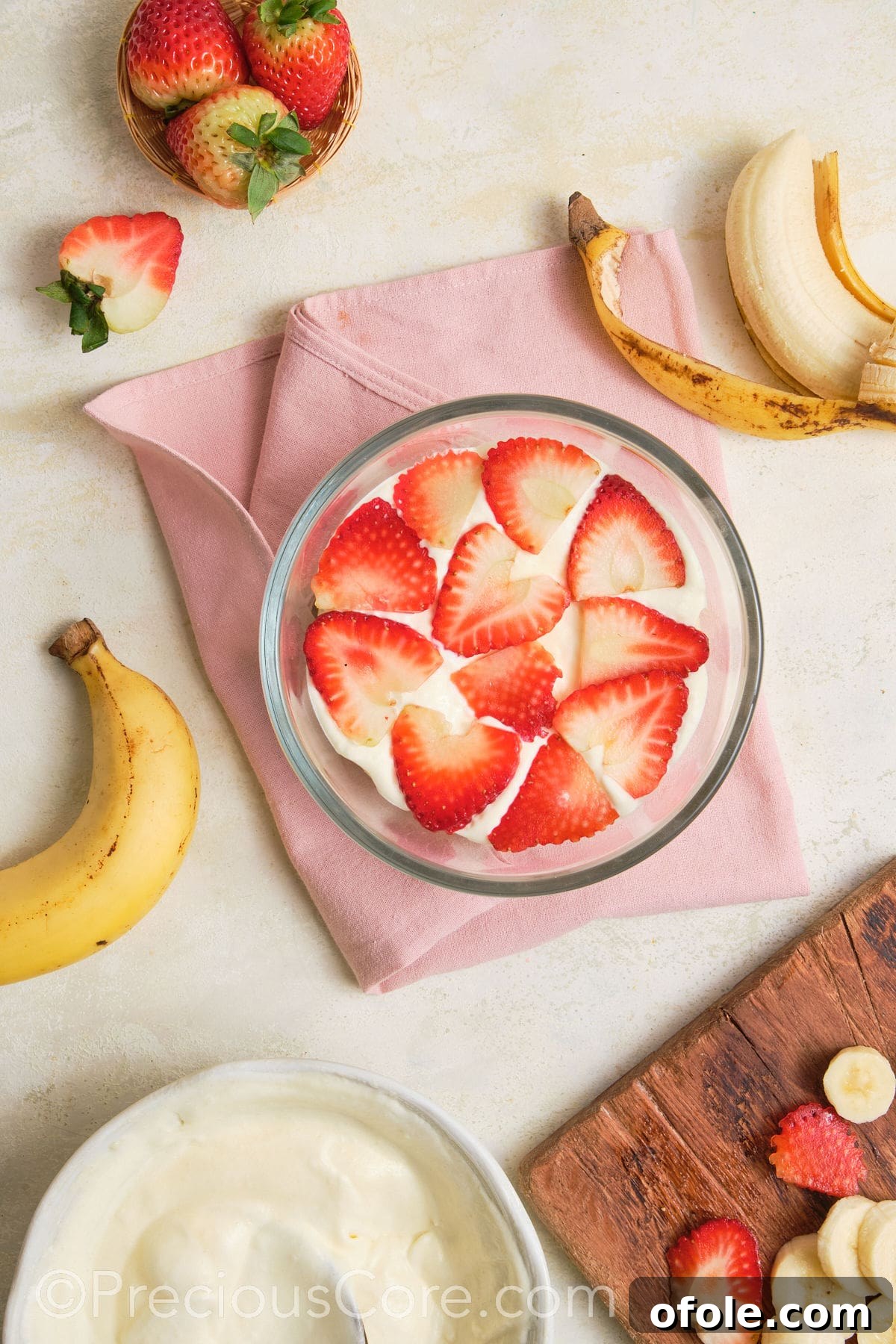 Dreamy Strawberry Banana Pudding 13 Vibrant sliced strawberries arranged beautifully over a layer of bananas and pudding in a dessert dish.