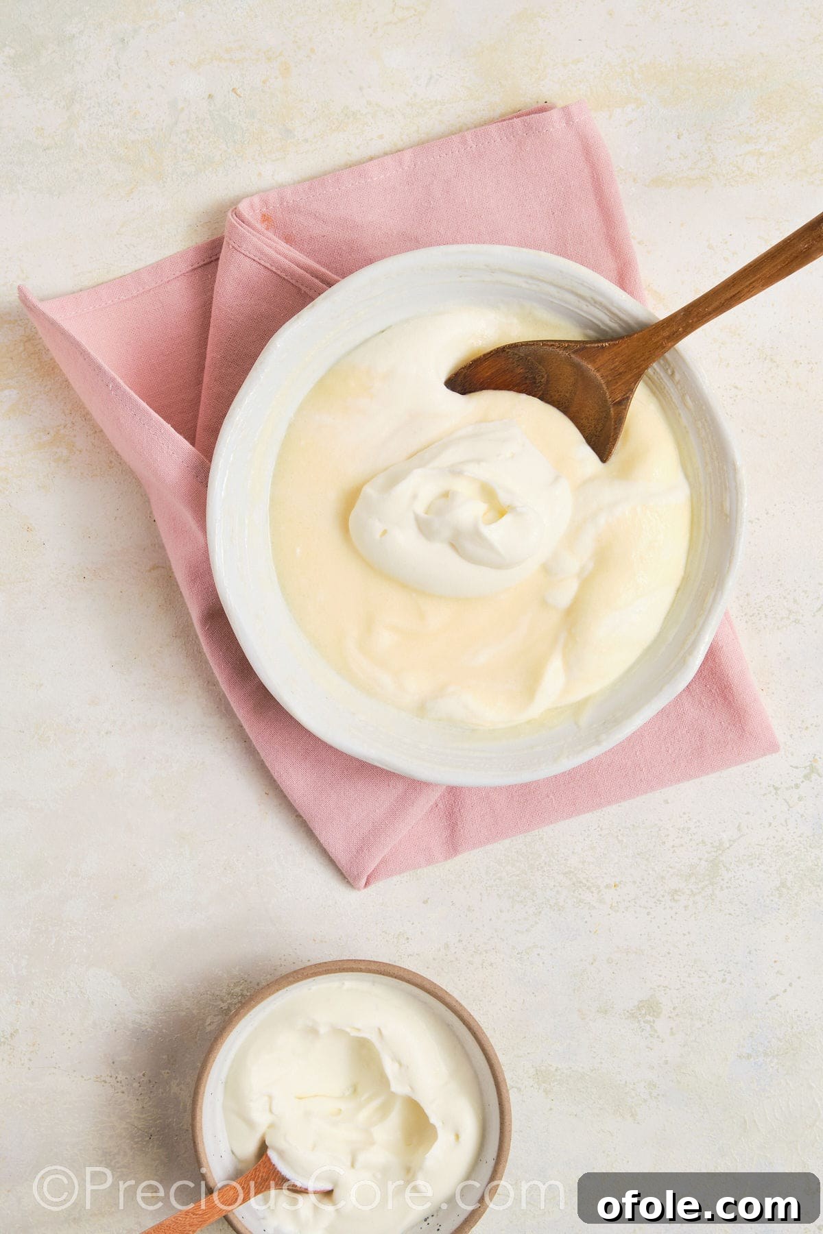 Dreamy Strawberry Banana Pudding 9 A spatula gently folding creamy whipped topping into the prepared banana pudding mix, creating a light and airy texture.