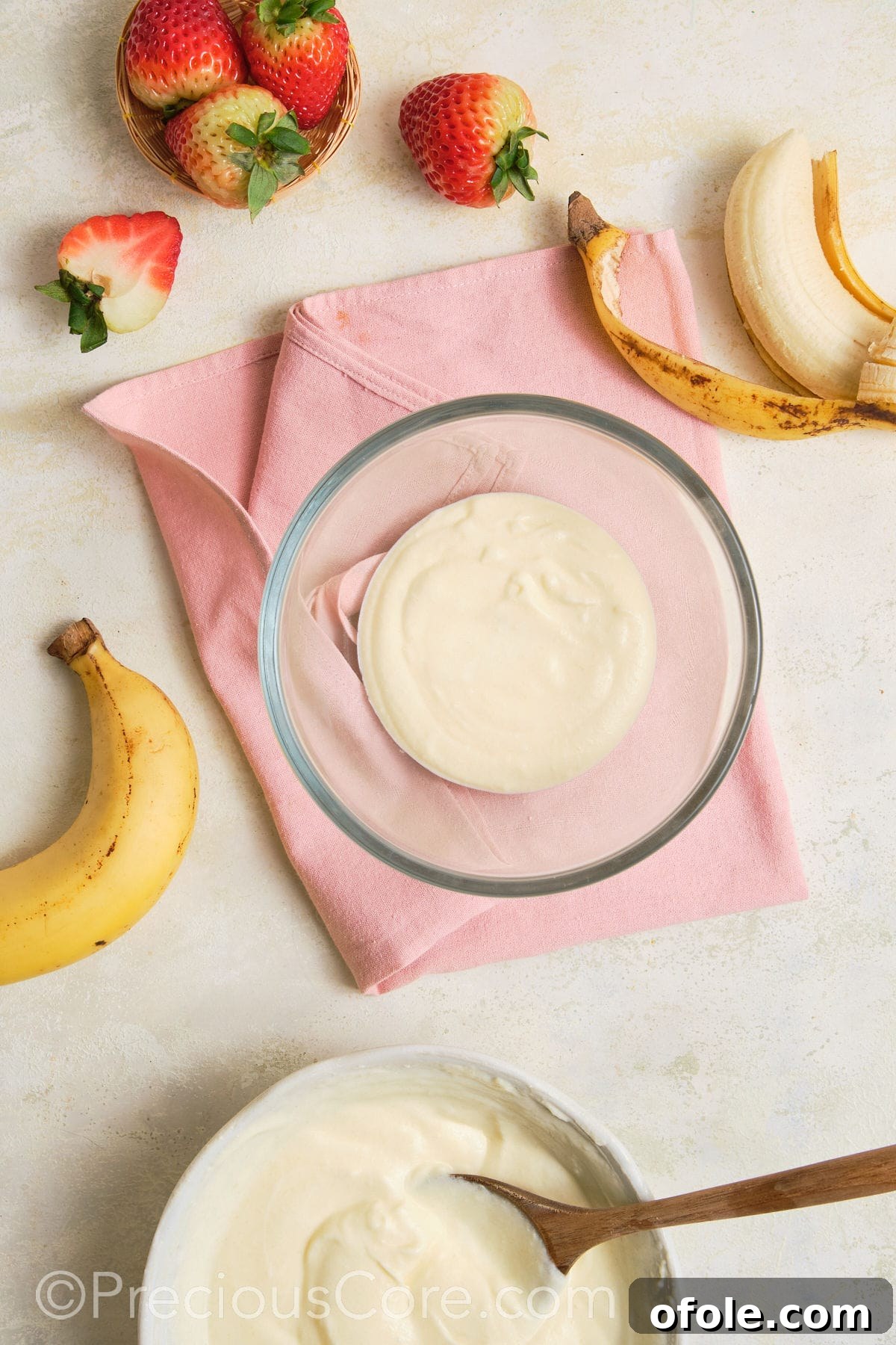 Dreamy Strawberry Banana Pudding 10 A base layer of creamy vanilla pudding spread evenly across the bottom of a transparent trifle bowl, ready for fruit layers.