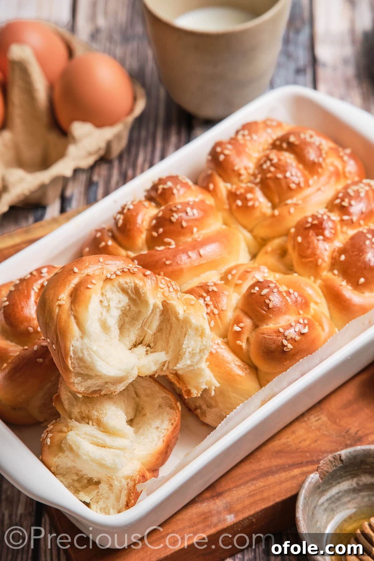 Challah roll cut in half to reveal its soft, airy texture.