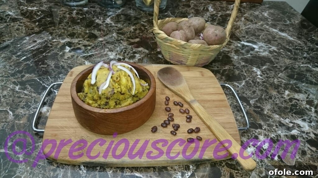 A bowl of Tukuni, a traditional Cameroonian mashed potatoes and beans dish.