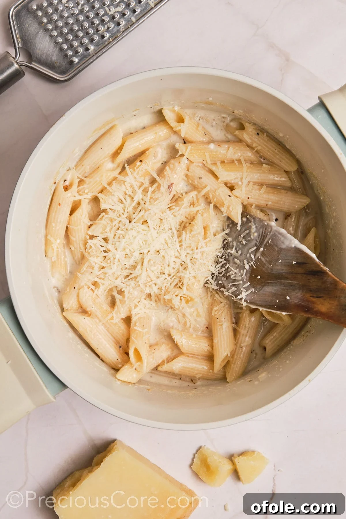 One Pot Wonder Creamy Chicken Pasta 16 Parmesan added to the pot of creamy pasta.