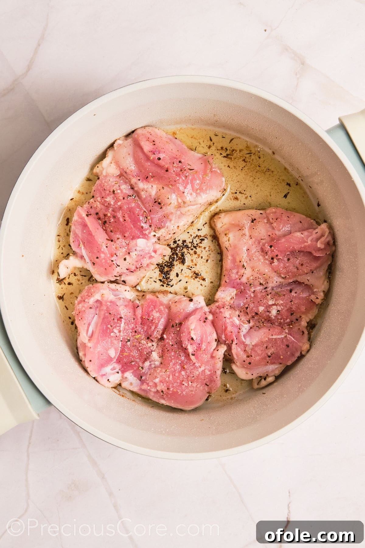 One Pot Wonder Creamy Chicken Pasta 8 Boneless chicken thighs cooking in a pot.