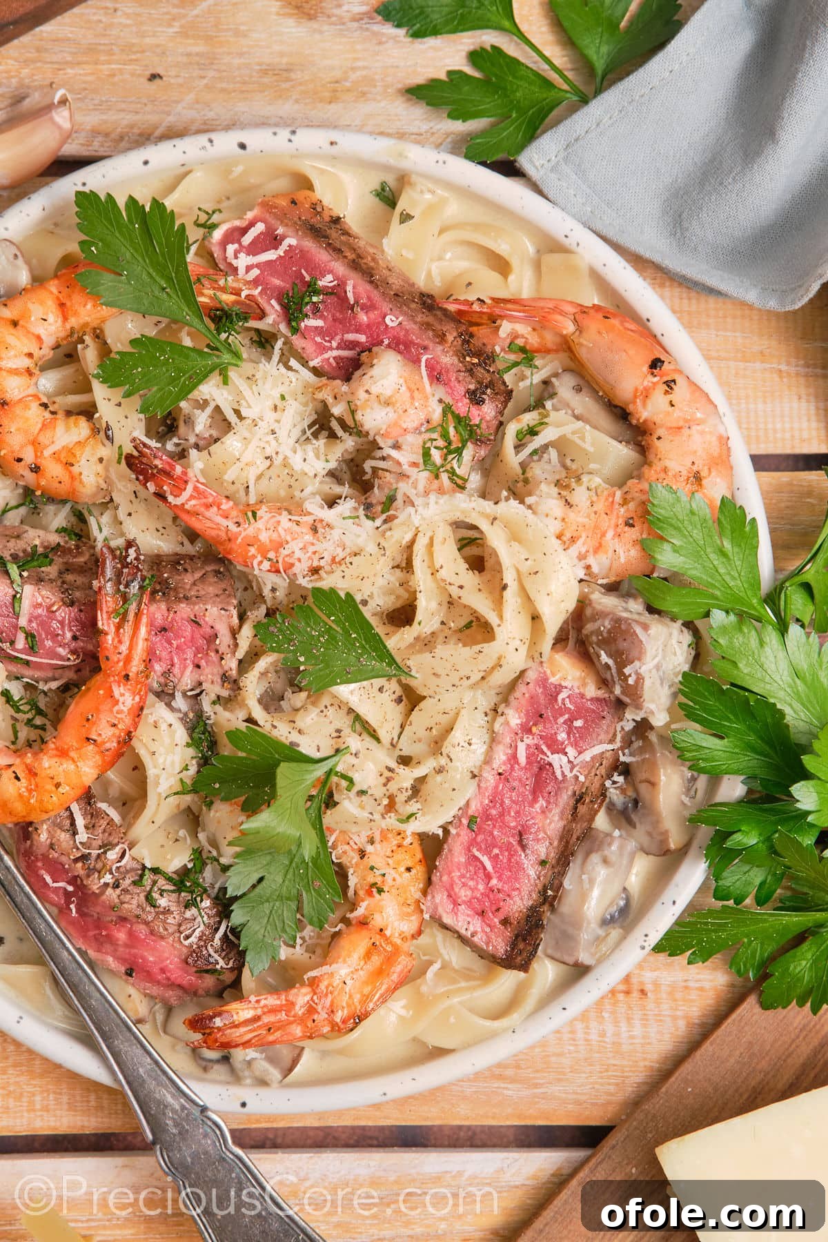 Land and Sea Pasta 2 Creamy pasta topped with juicy steak and shrimp.