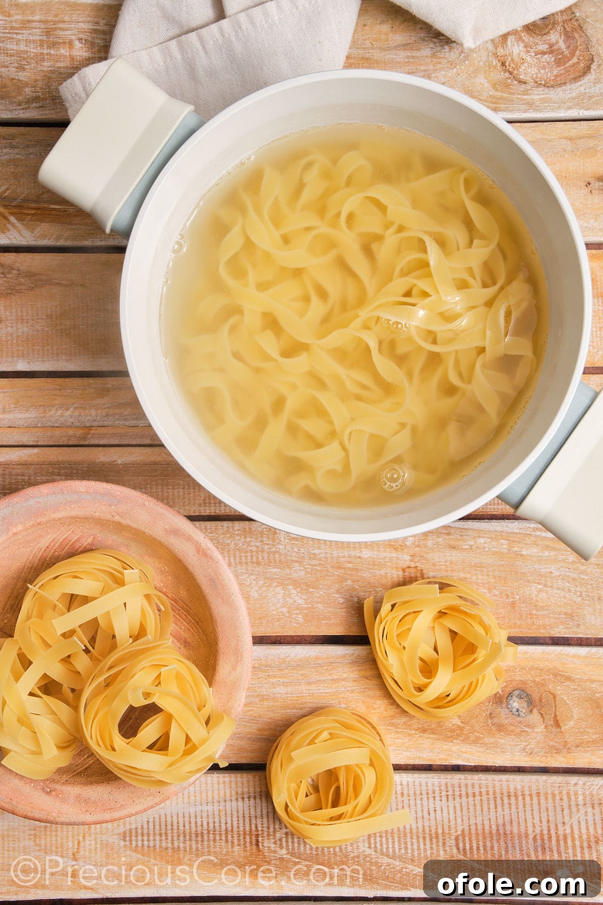 Land and Sea Pasta 7 Pasta cooking in a pot of water.