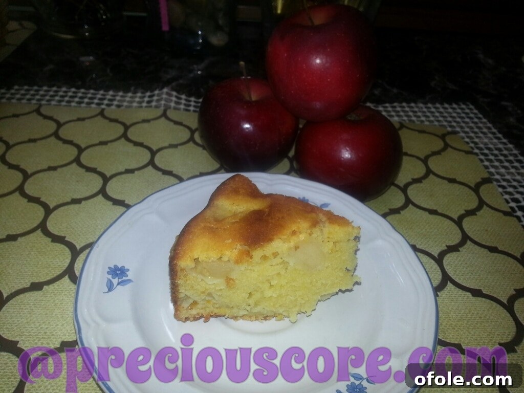 A delightful slice of homemade apple cake, lovingly prepared and presented, likely from a family baking session.
