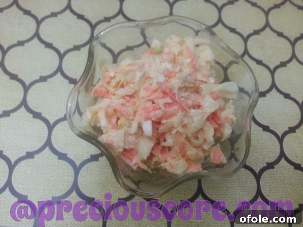A bowl of freshly made coleslaw, showcasing crisp vegetables and a creamy dressing.