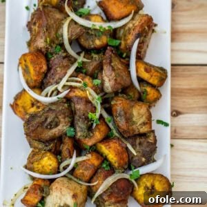 Fried pork an plantains topped with sliced onions.