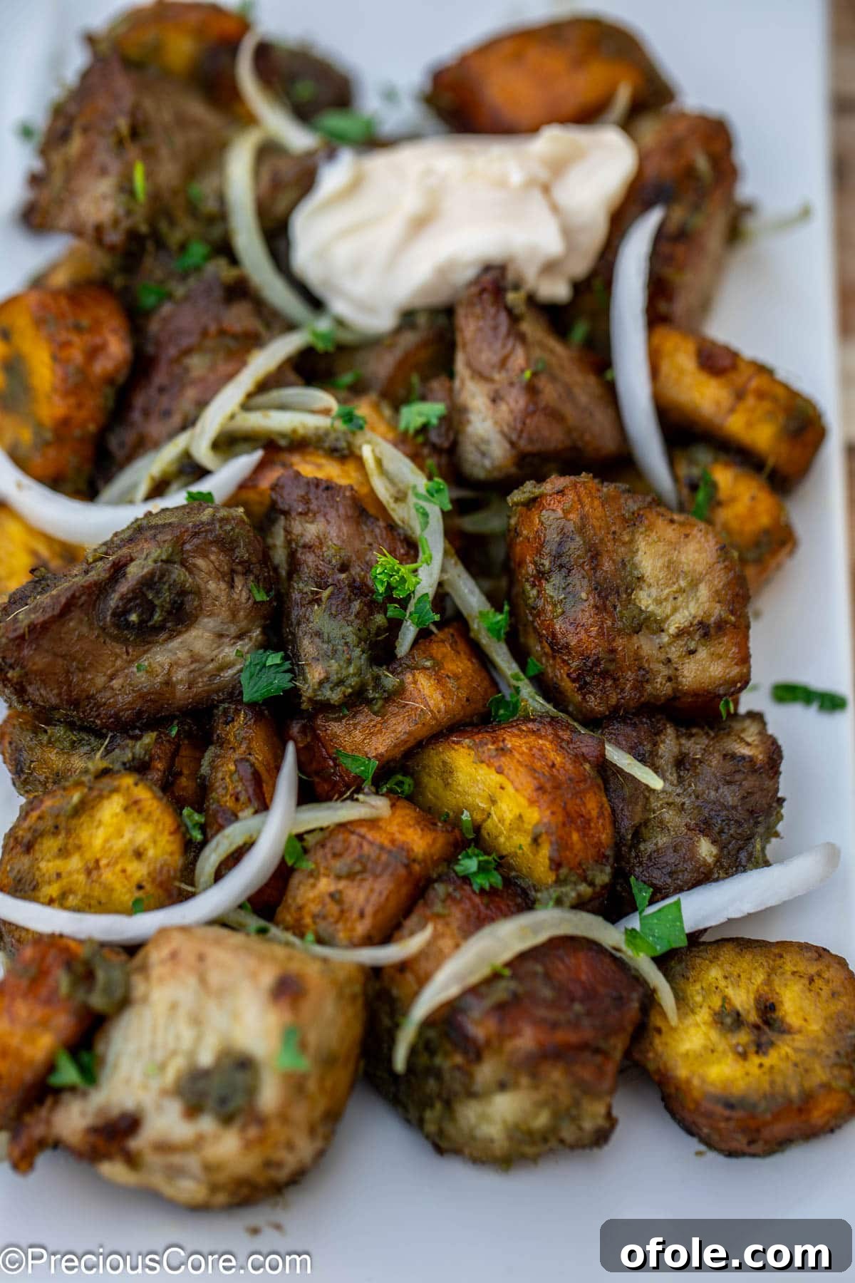 Crispy Pork with Golden Plantains 4 Close-up of finished meat and plantain dish.
