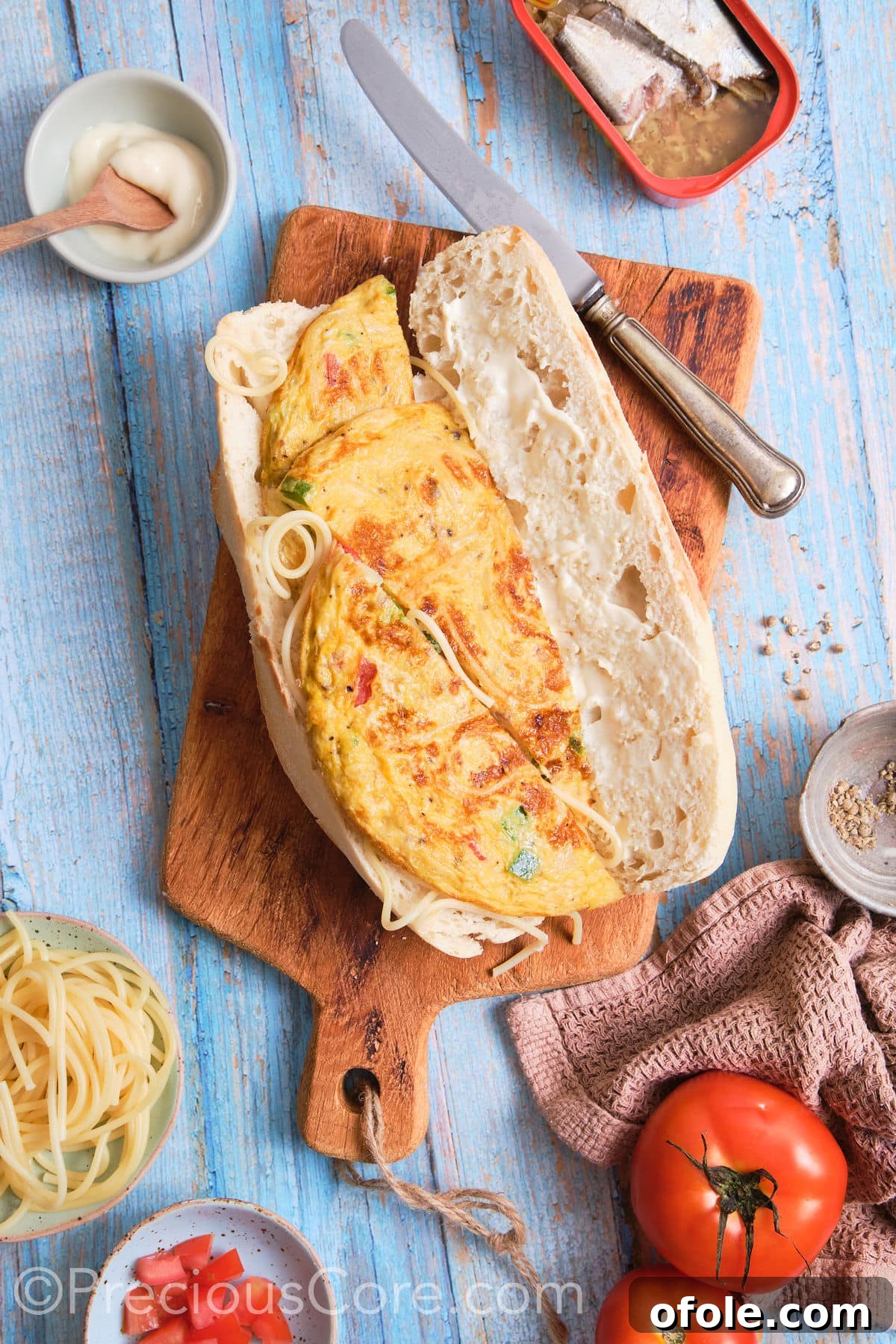 Cameroon's Signature Spaghetti Omelette Sandwich 3 A French baguette opened lengthwise, with one side ready to be filled with spaghetti omelette.