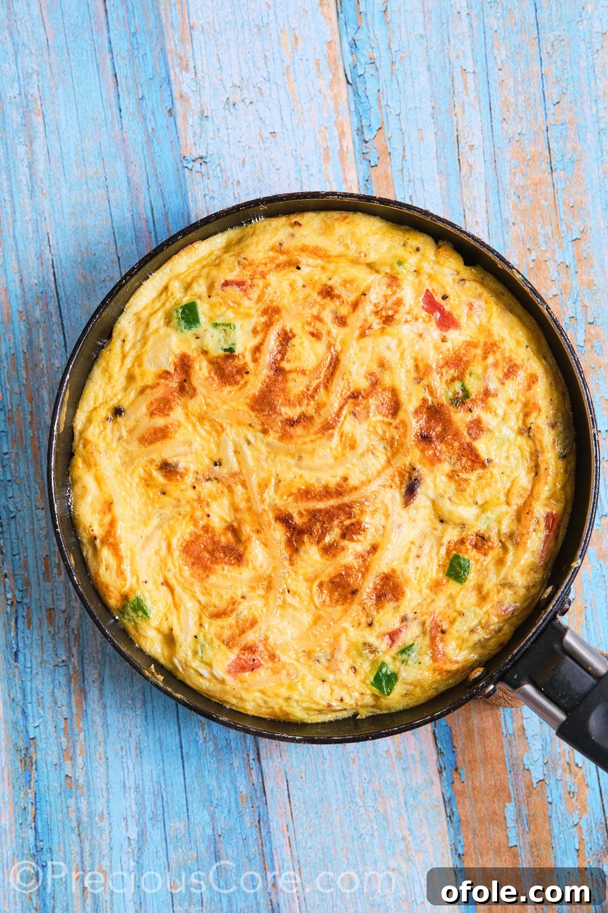 Cameroon's Signature Spaghetti Omelette Sandwich 8 The spaghetti omelette perfectly flipped in the skillet, continuing to cook to a golden brown.