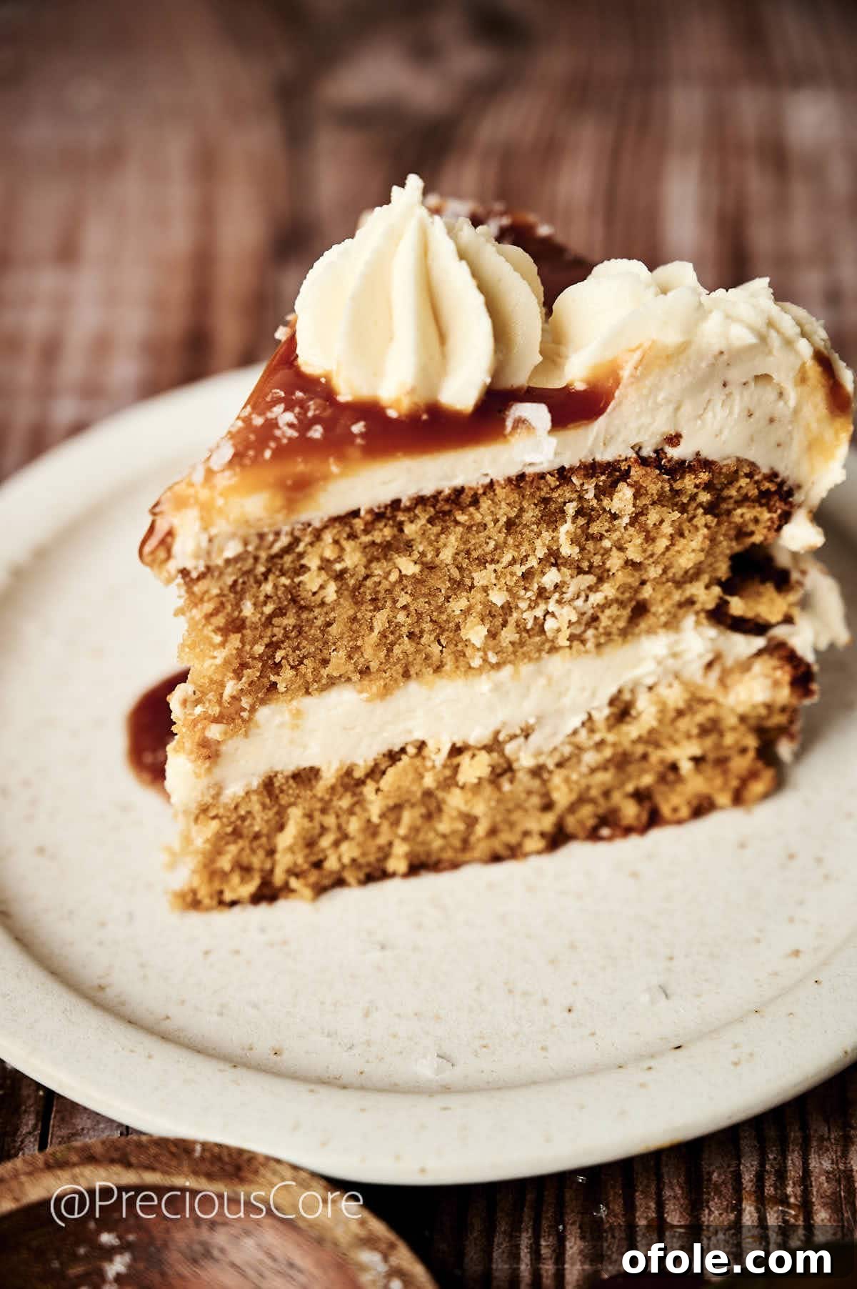 Salted Caramel Dream Cake 2 A perfectly sliced piece of salted caramel cake, showcasing its moist layers and creamy frosting.