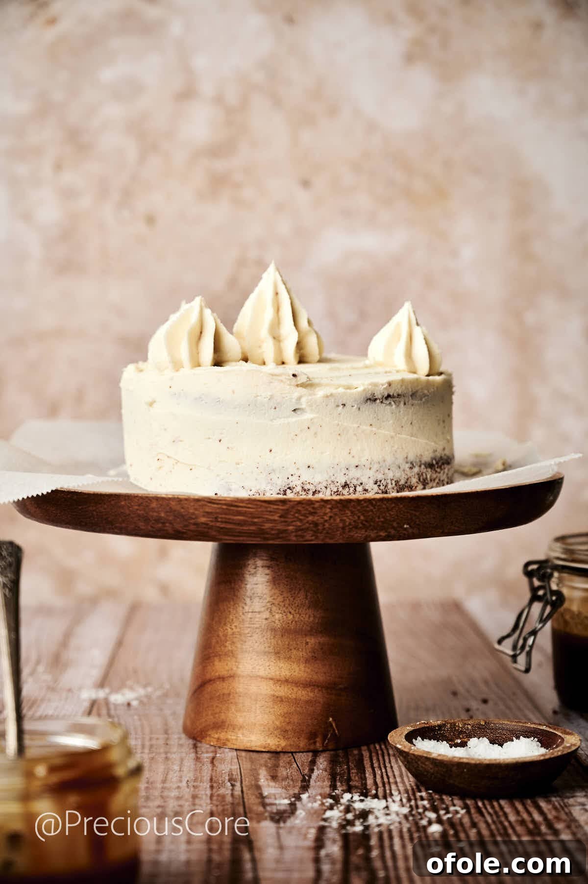 Salted Caramel Dream Cake 14 A beautifully assembled salted caramel cake with piped frosting on top, ready for final decoration.