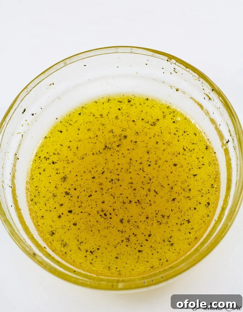Crimson & Emerald Harvest 3 Freshly prepared honey lemon dressing, whisked to perfection and presented in a glass bowl, ready to elevate any green salad