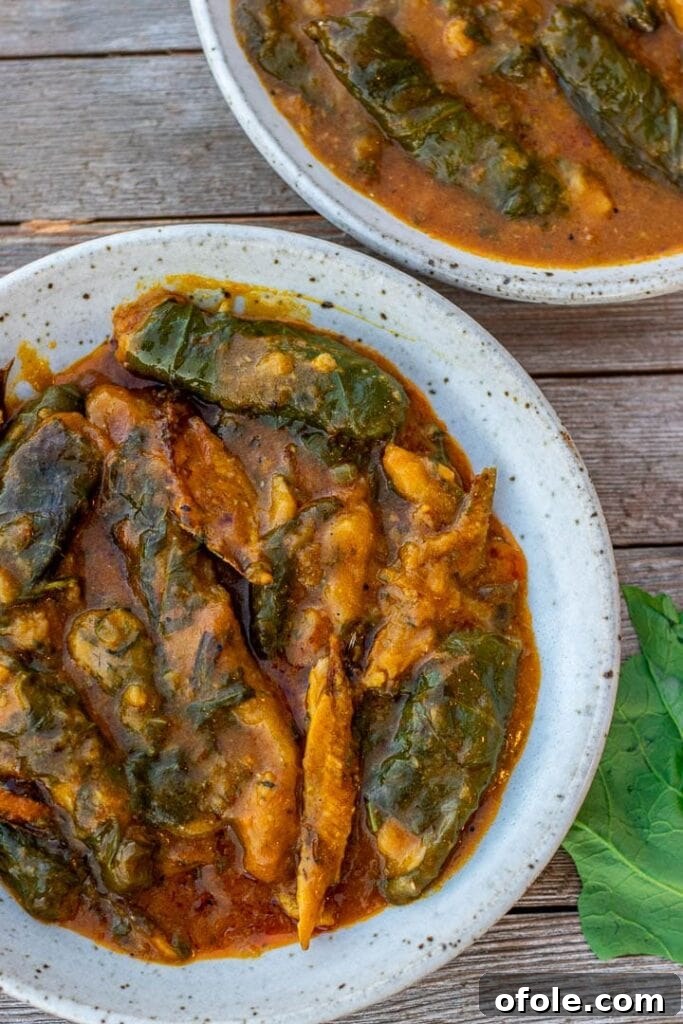A beautifully presented bowl of Ekwang, a rich and hearty Cameroonian cocoyam dish, garnished and ready to be enjoyed.
