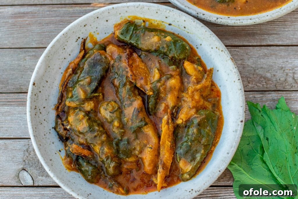 A landscape orientation picture of a large, steaming pot of Ekwang, showcasing the generous quantity and the richness of the communal dish.
