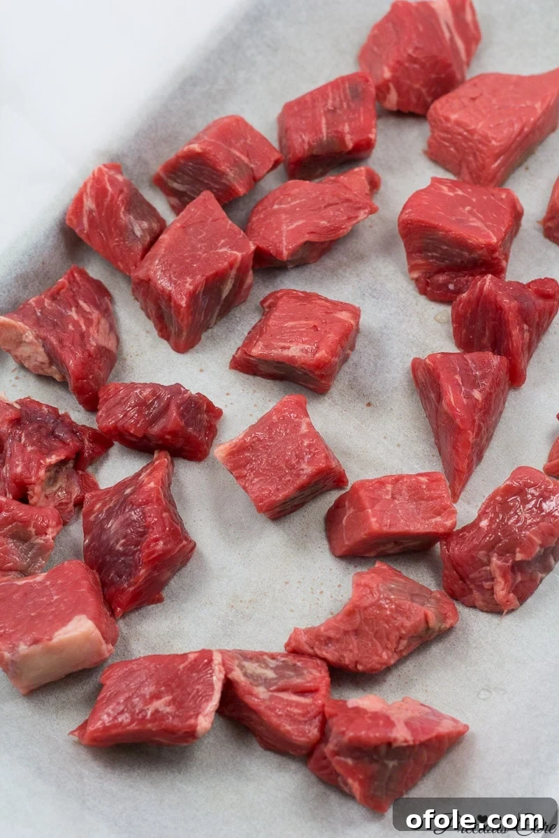 African Smokehouse Secrets for Your Home 2 Cubed beef on a lined baking sheet.