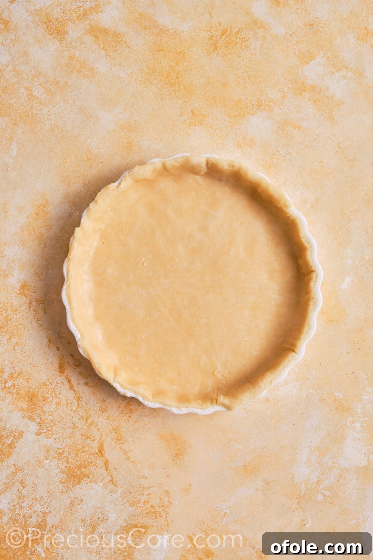 Creamy Pumpkin Pie Without Evaporated Milk 14 The homemade pumpkin pie dough carefully fitted into a white ceramic pie dish, with crimped edges, ready for the filling.