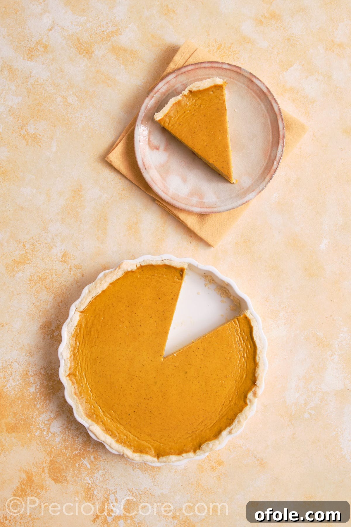 Creamy Pumpkin Pie Without Evaporated Milk 17 A freshly baked homemade pumpkin pie, cooled and ready to be served, resting on a rustic wooden board.