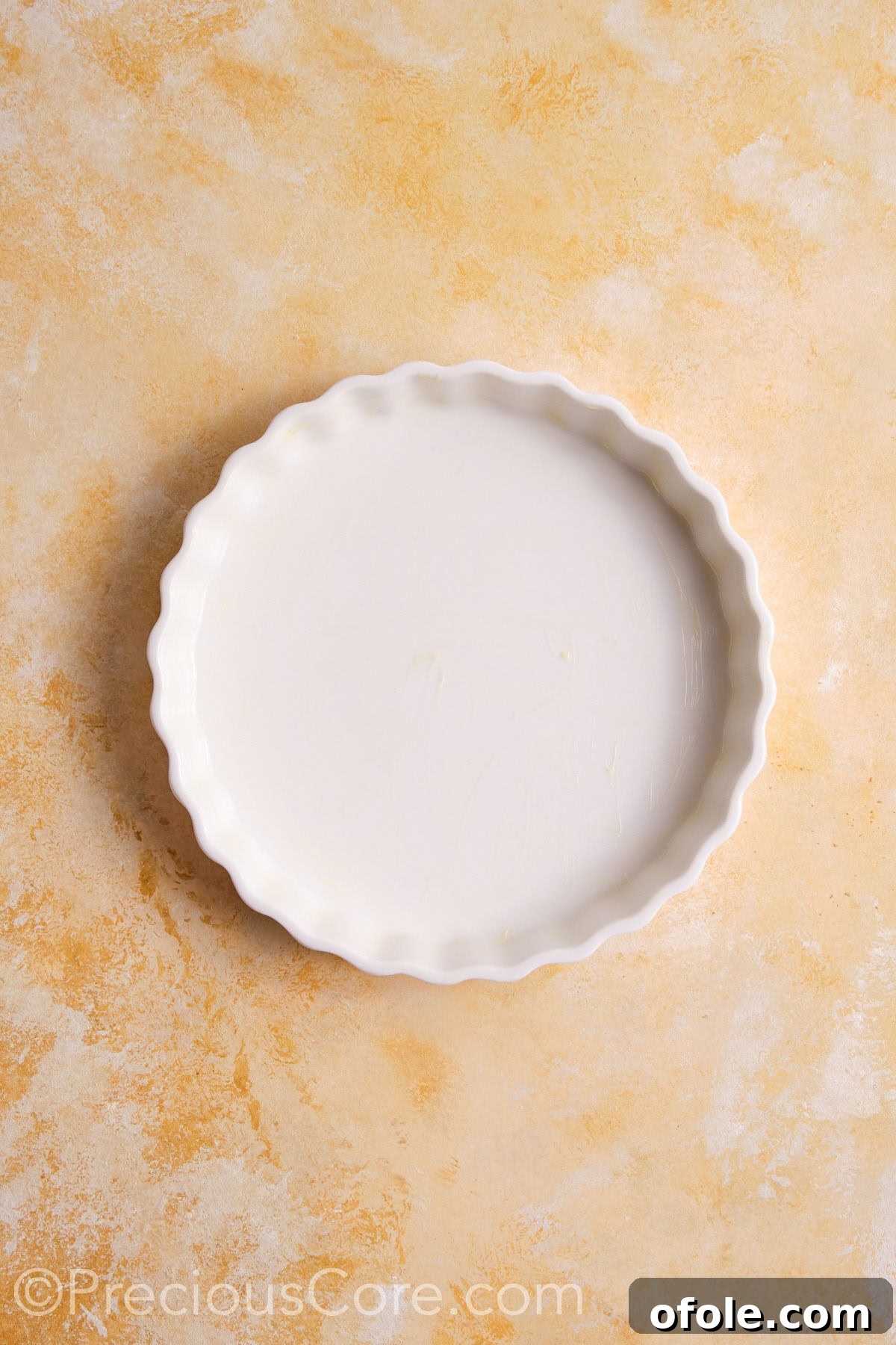 Creamy Pumpkin Pie Without Evaporated Milk 6 A white ceramic pie dish, lightly greased and ready for the pie crust.
