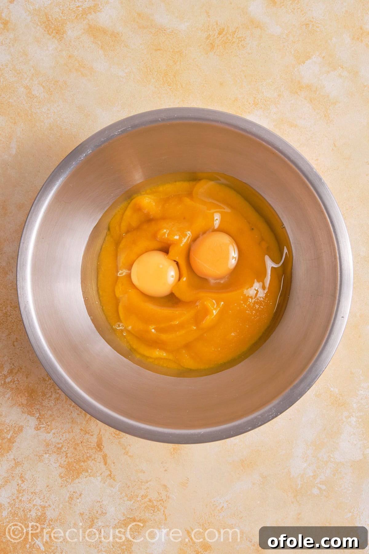 Creamy Pumpkin Pie Without Evaporated Milk 10 A bowl containing beaten eggs and smooth pumpkin puree, ready to be combined for the pie filling.