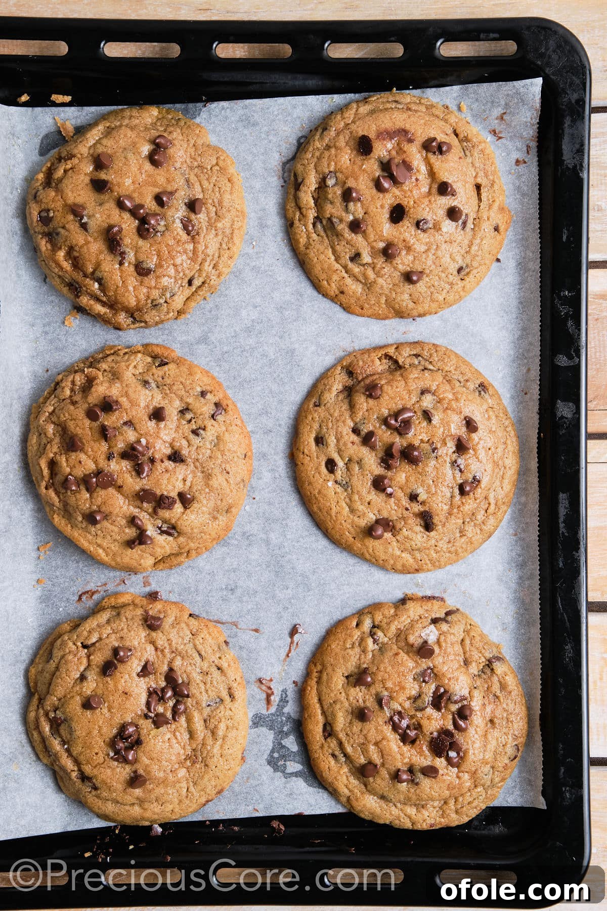 6 cinnamon chocolate chip cookies on a baking sheet.