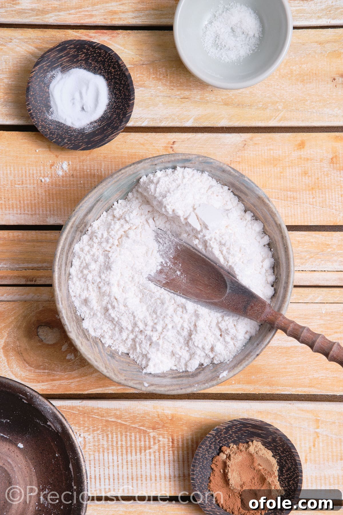 adding dry ingredients for the cookies to a bowl. 
