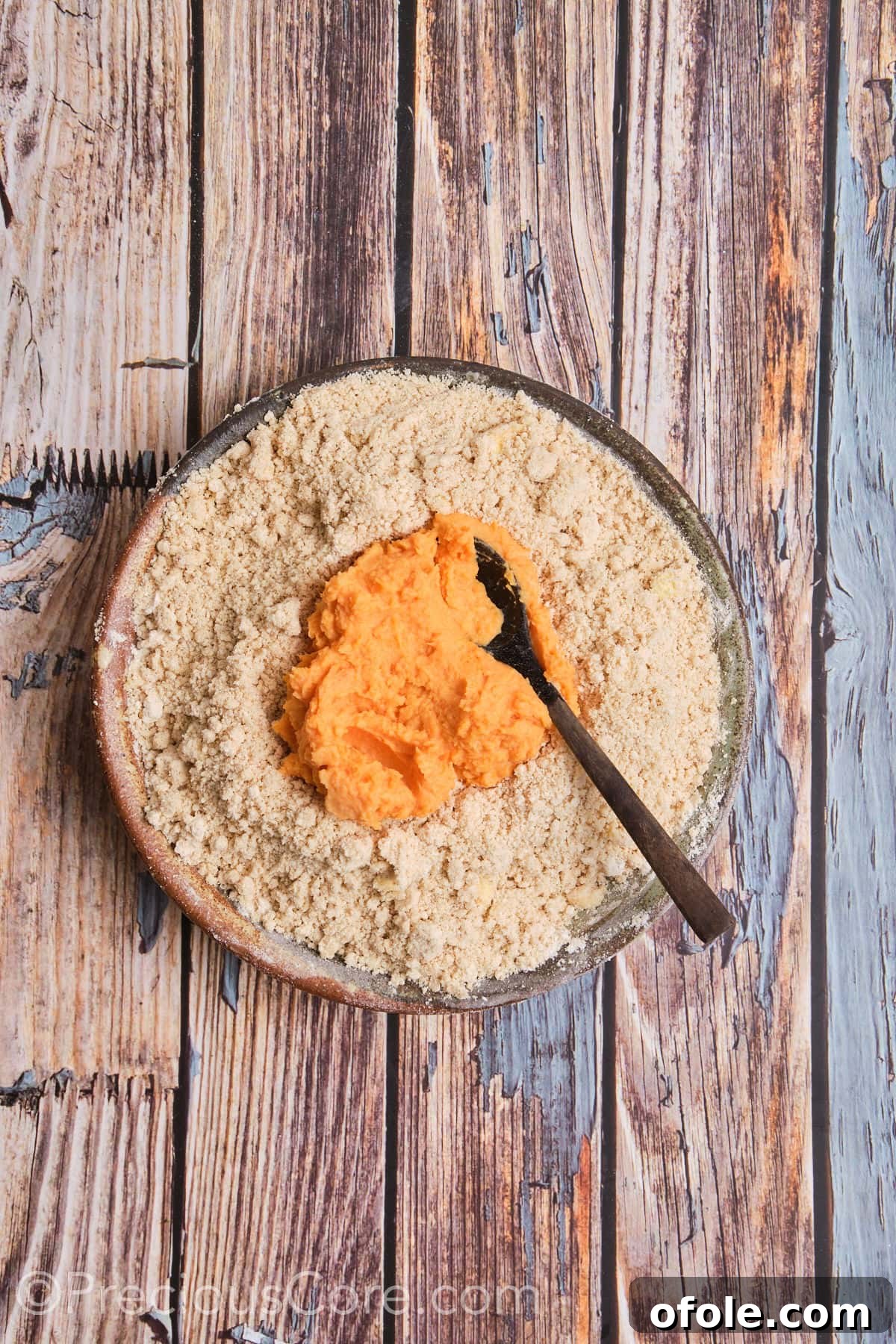 Spiced Sweet Potato Scones 11 The vibrant sweet potato mixture is being poured into the bowl of dry ingredients, signaling the start of dough formation.