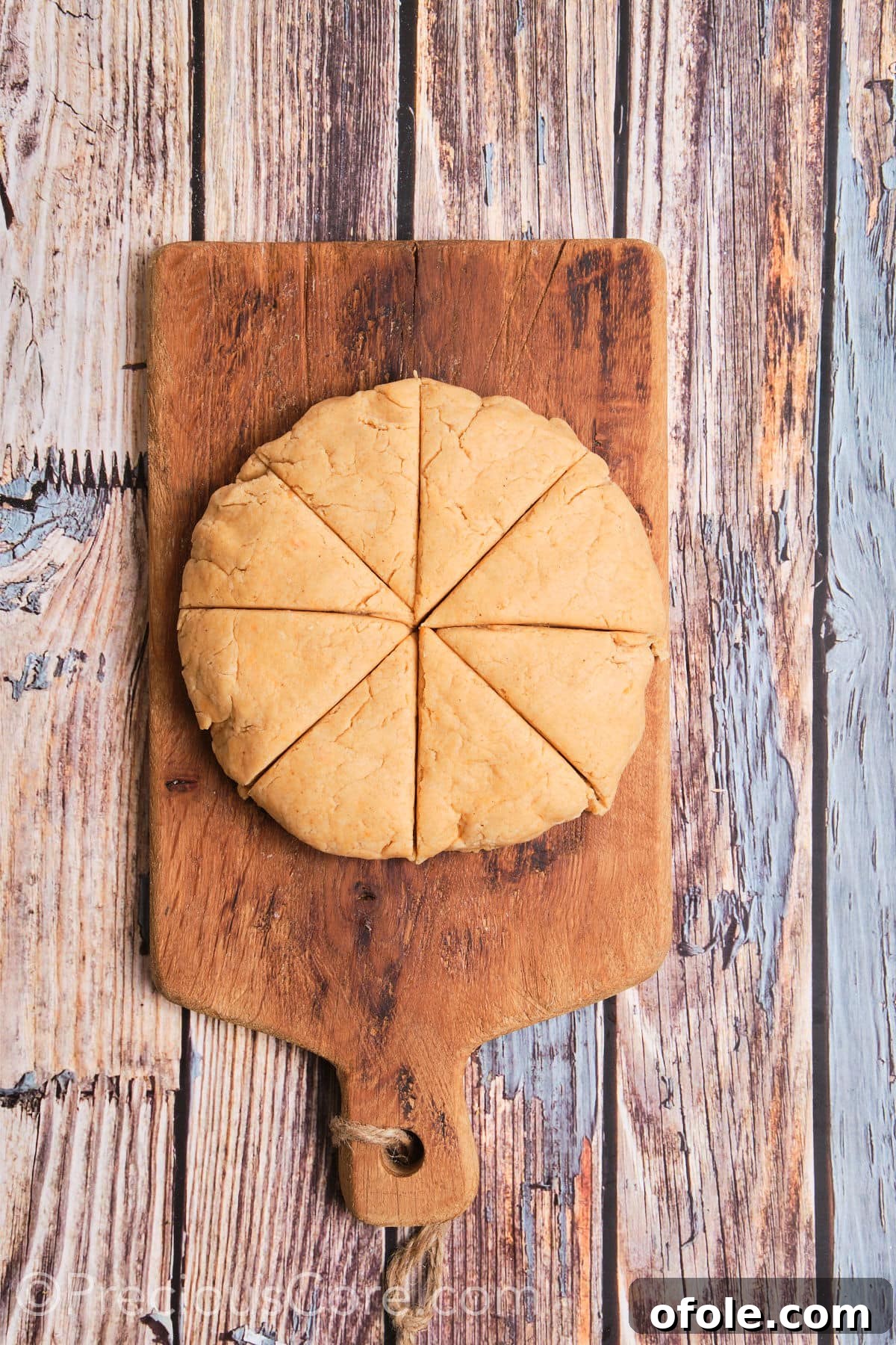 Golden Sweet Potato Scones 13 The scone dough expertly shaped into a 7-inch round and precisely cut into 8 uniform wedges, ready for baking.