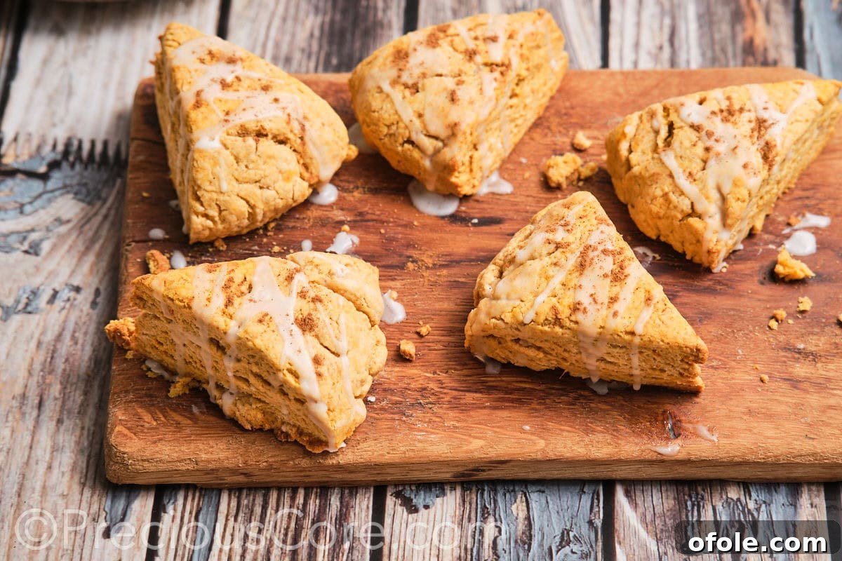 Golden Sweet Potato Scones 20 A selection of freshly baked homemade sweet potato scones, presented enticingly on a rustic chopping board, highlighting their golden crusts.