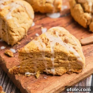 A triangle sweet potato scone with a white glaze on top.