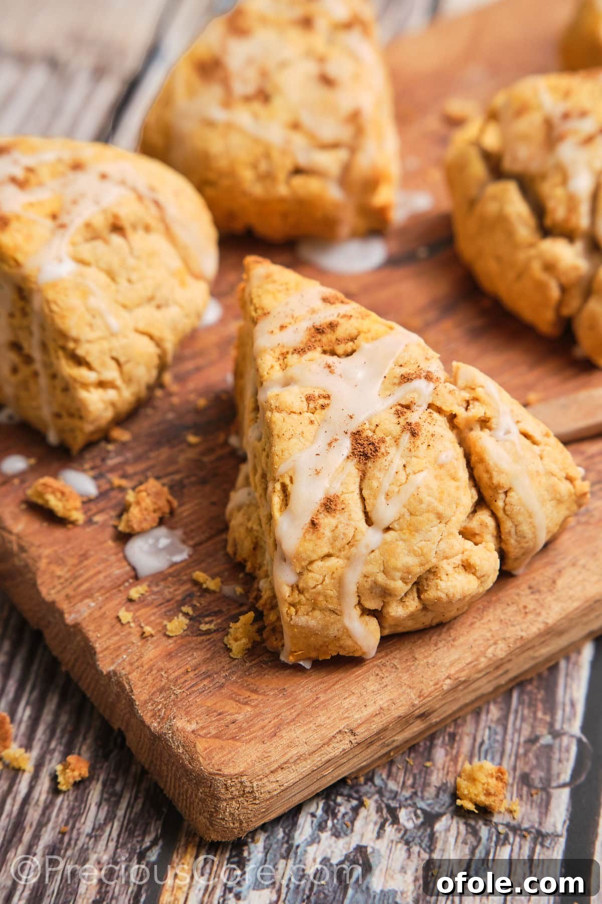 Golden Sweet Potato Scones 4 A close-up shot highlighting the inviting texture and delicate glaze of a single sweet potato scone, showcasing its golden-brown crust.