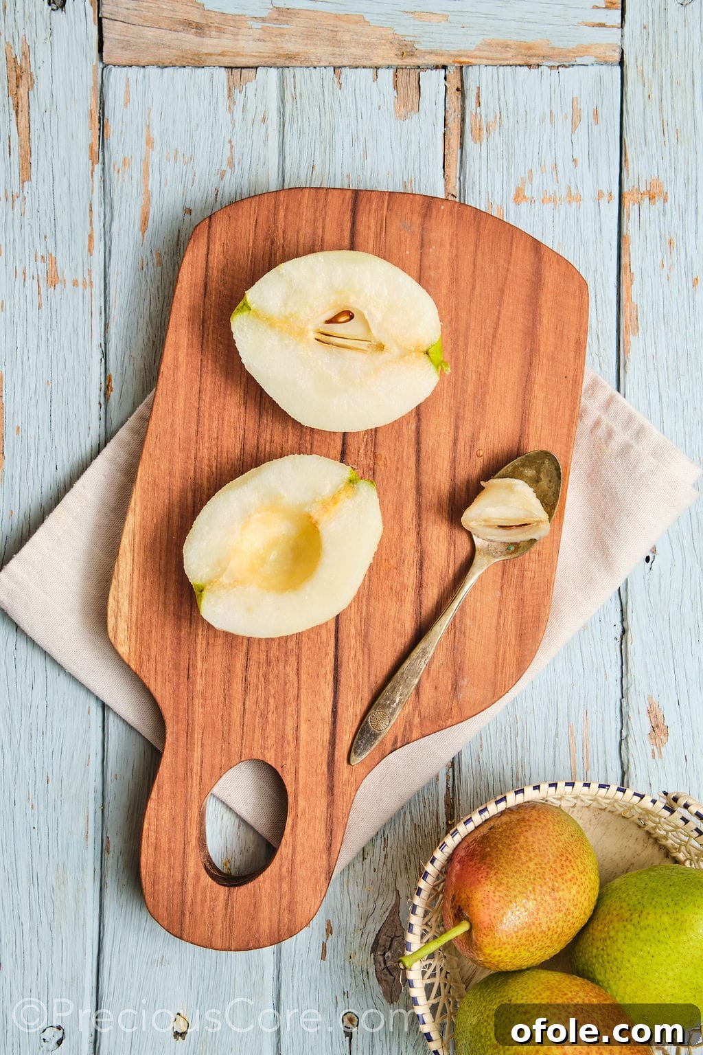 Fresh, ripe pears, meticulously peeled and cored, ready for slicing.