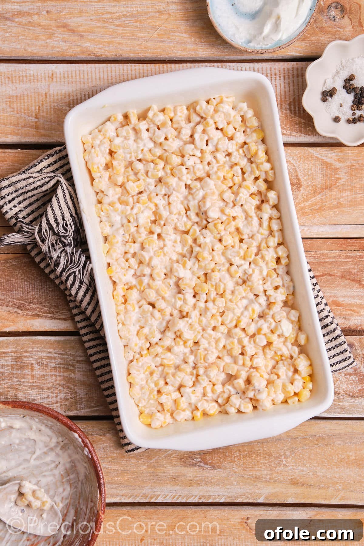 Fiesta Street Corn Bake 6 Creamy corn mixture evenly spread in a baking dish, ready to be placed in the oven.