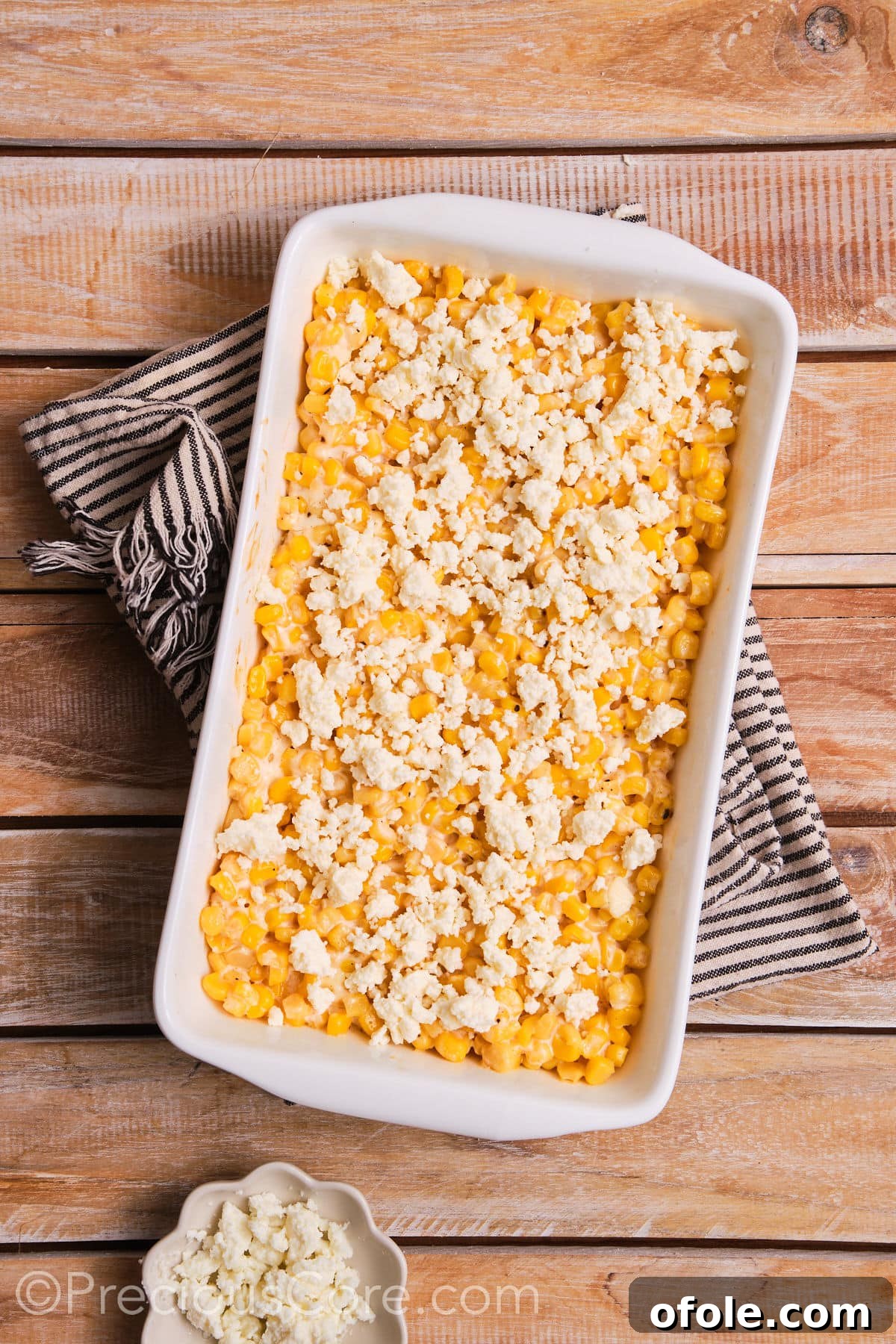 Fiesta Street Corn Bake 7 The baked corn casserole generously topped with crumbled queso fresco, glistening and ready for final garnishes.