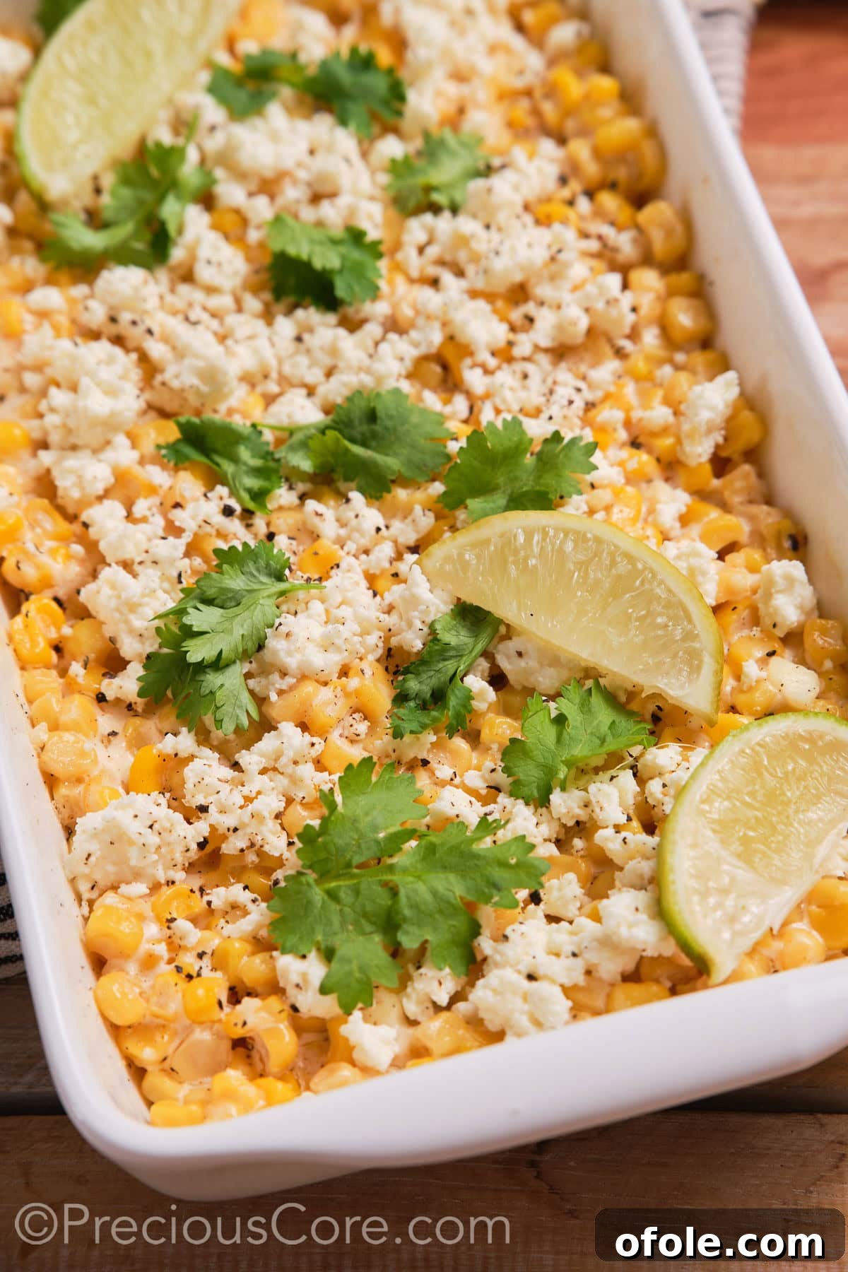 Fiesta Street Corn Bake 9 A close-up view of the Mexican street corn casserole, beautifully garnished with fresh lime wedges, highlighting its vibrant appeal.