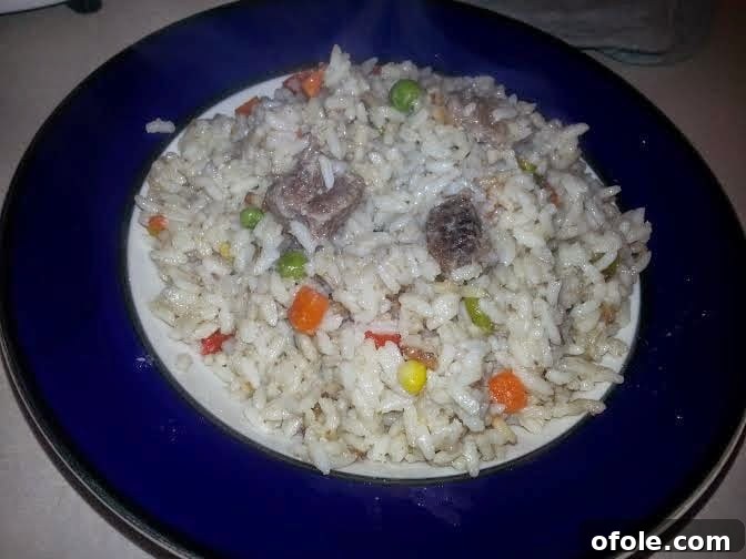 Exotic Delight: Coconut Infused Jollof Rice Creamy Coconut Jollof Rice served with garnishes