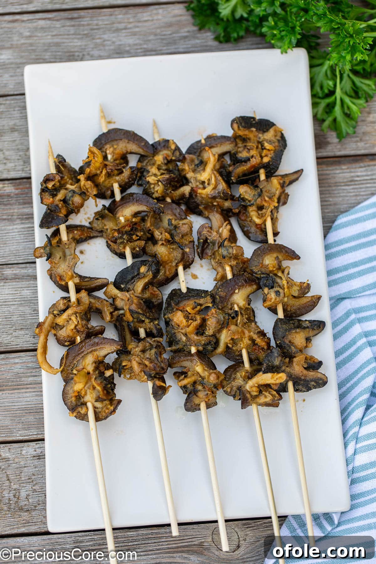 Savoring Cameroon's Snail Delicacy 4 Delicious Cameroonian street food snails expertly threaded on bamboo skewers, ready for serving.