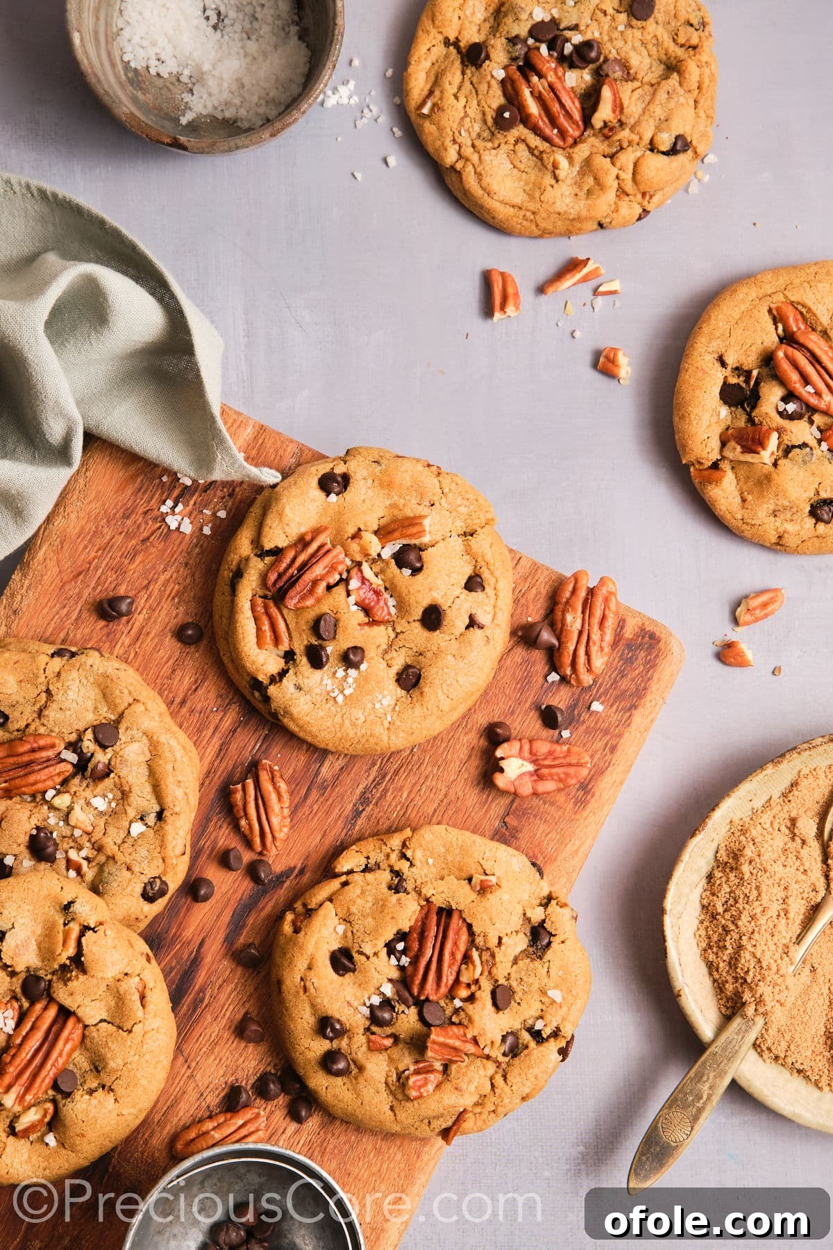 Decadent Brown Butter Pecan Delights 16 Cooled butter pecan cookies neatly arranged on a rustic chopping board, ready to be served.