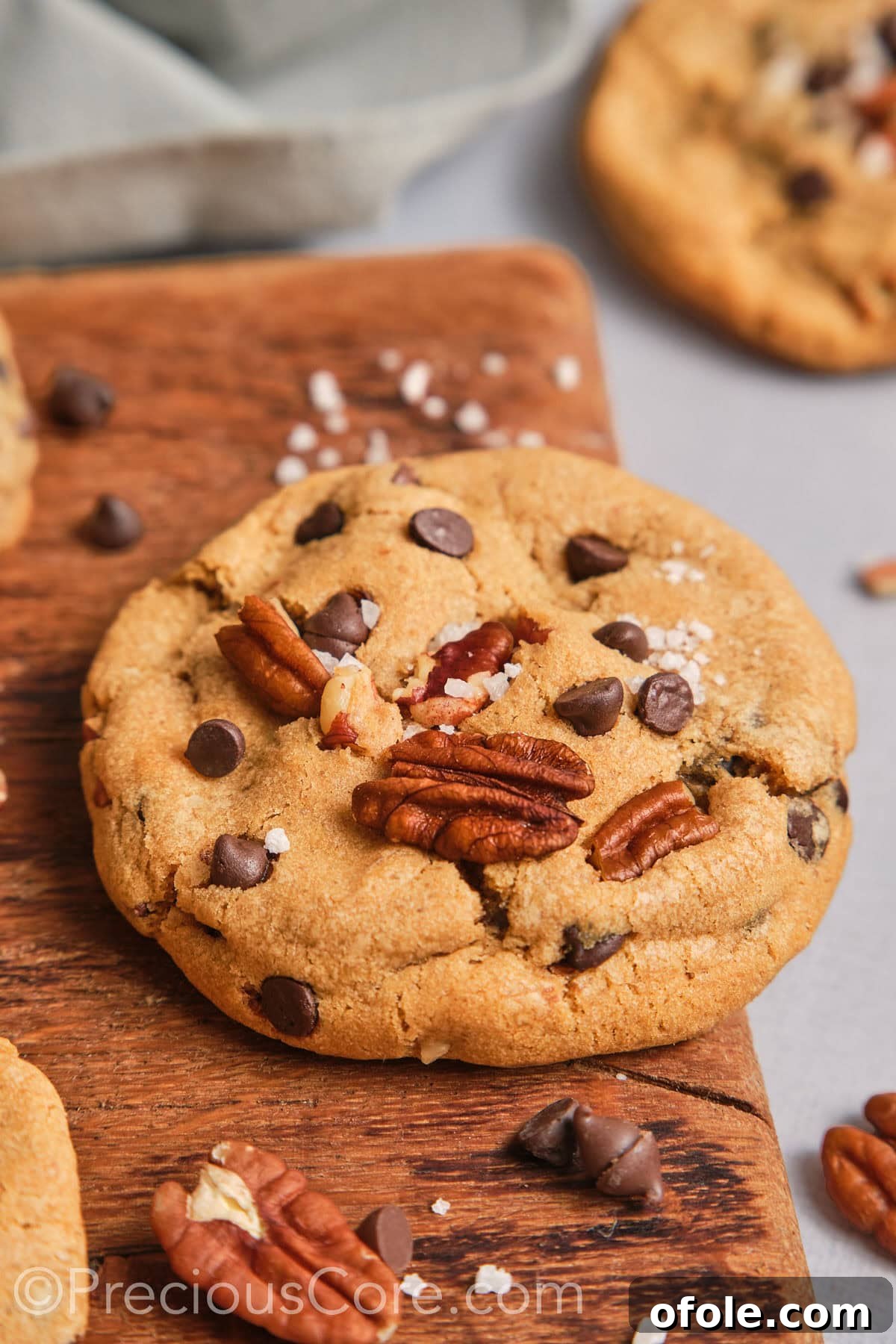 Decadent Brown Butter Pecan Delights 3 Close-up view of a single large brown butter pecan cookie, highlighting its rich, textured surface and visible pecan pieces.