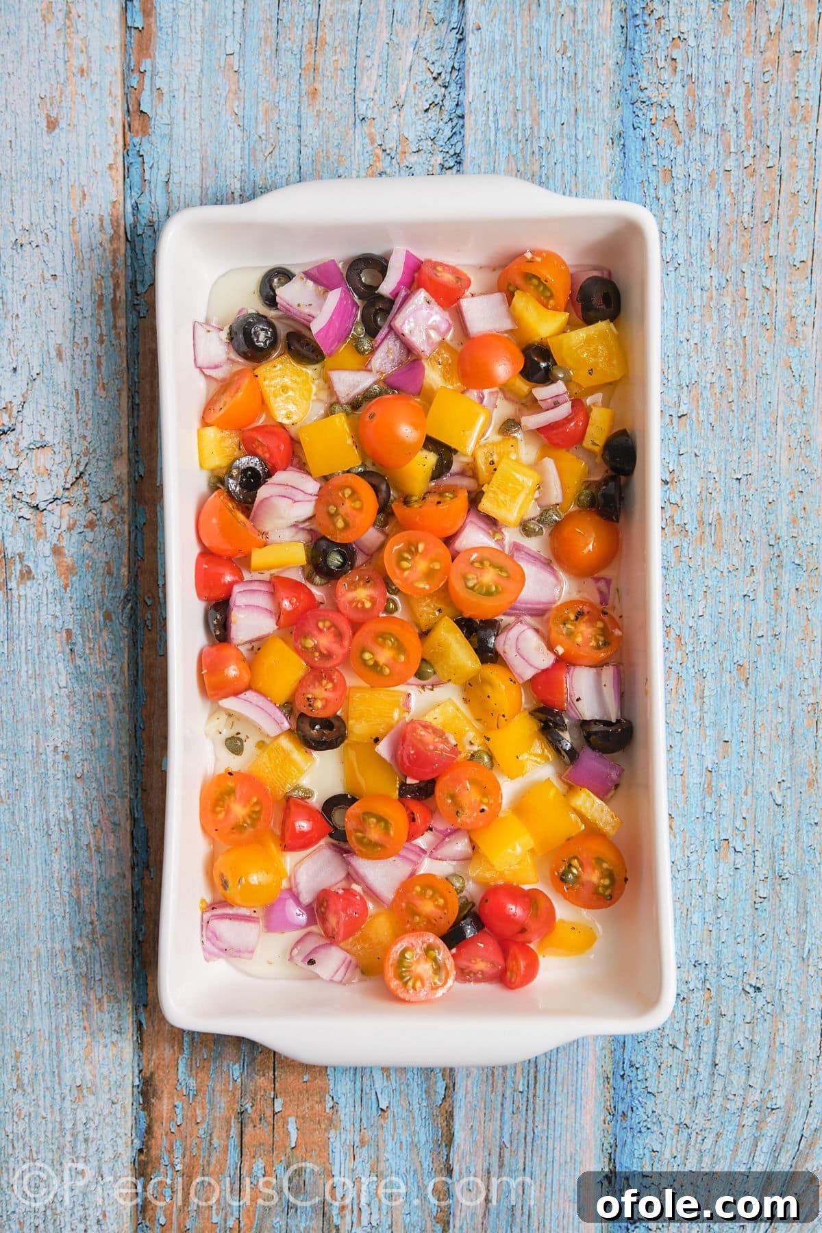 Vibrant Mediterranean Baked Fish 7 Chopped veggies arranged in a baking dish.