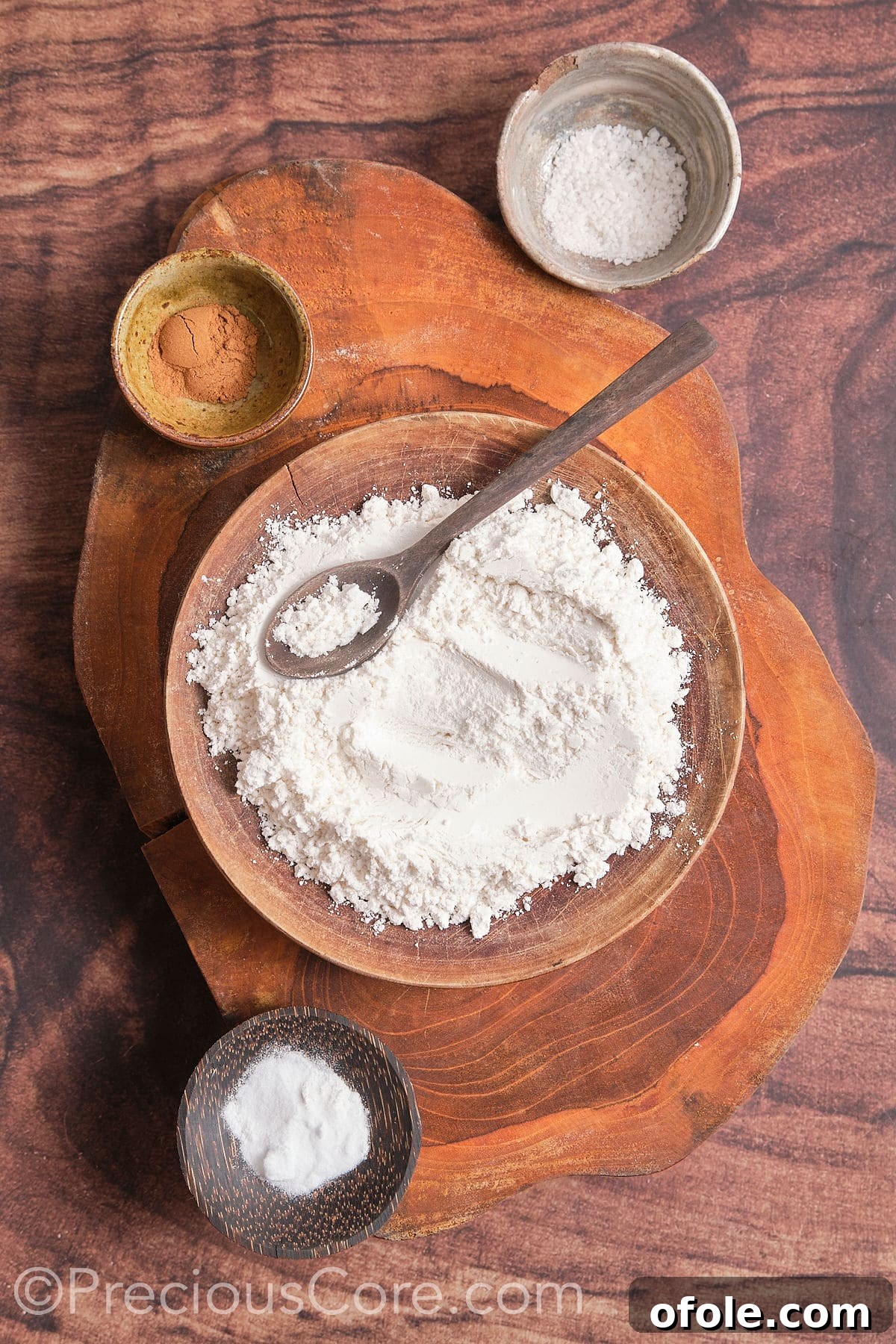 In a mixing bowl, take flour, baking soda, baking powder, salt, and cinnamon 