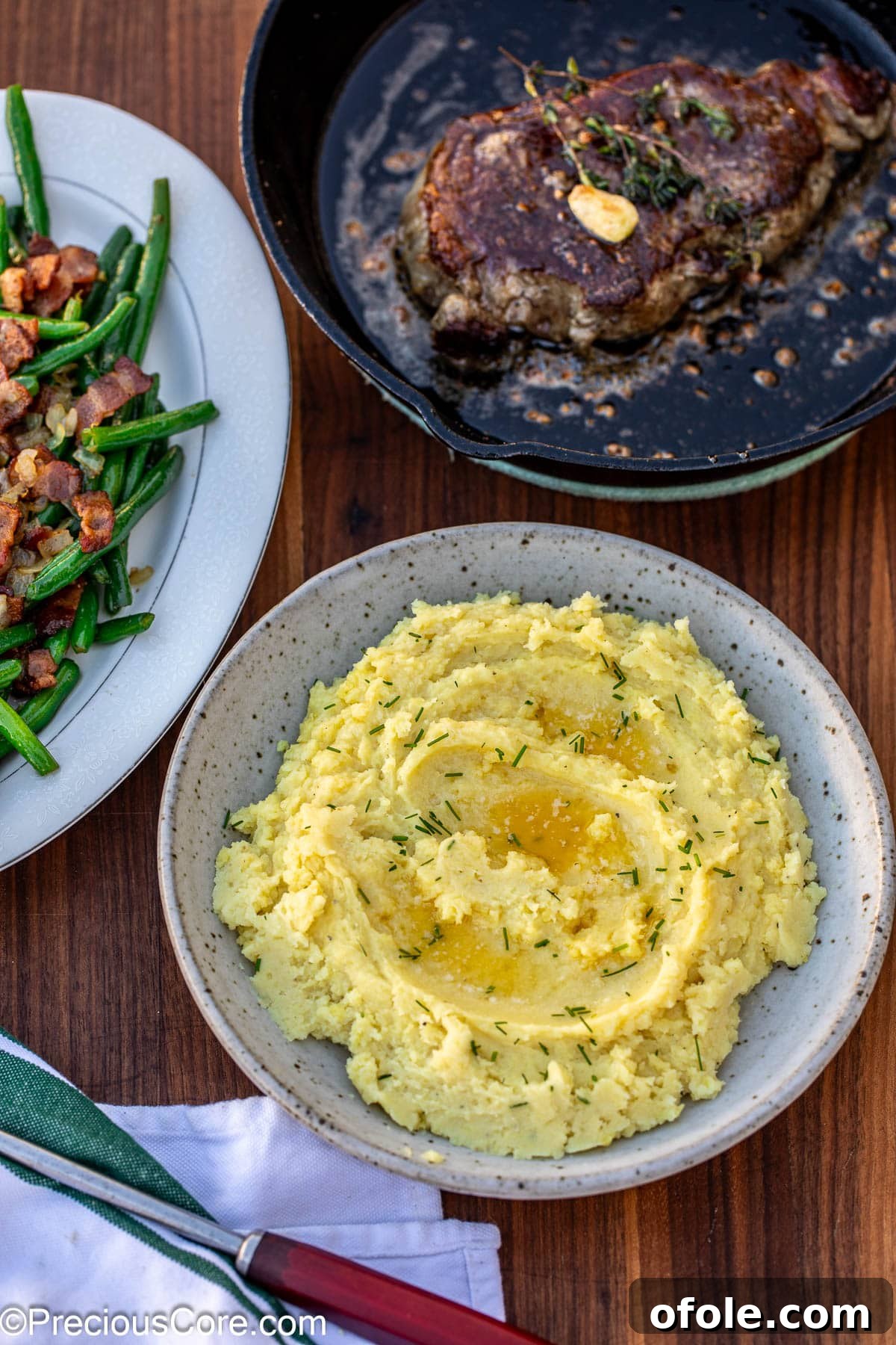 Velvety White Sweet Potato Puree 13 Creamy potatoes in a bowl topped with pools of butter.