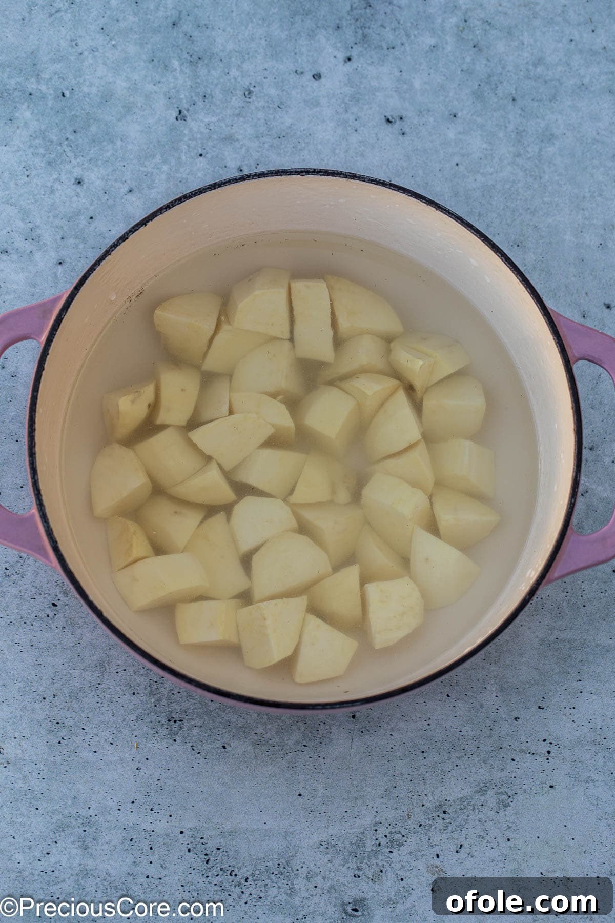 Velvety White Sweet Potato Puree 8 White sweet potatoes boiling in a pot.